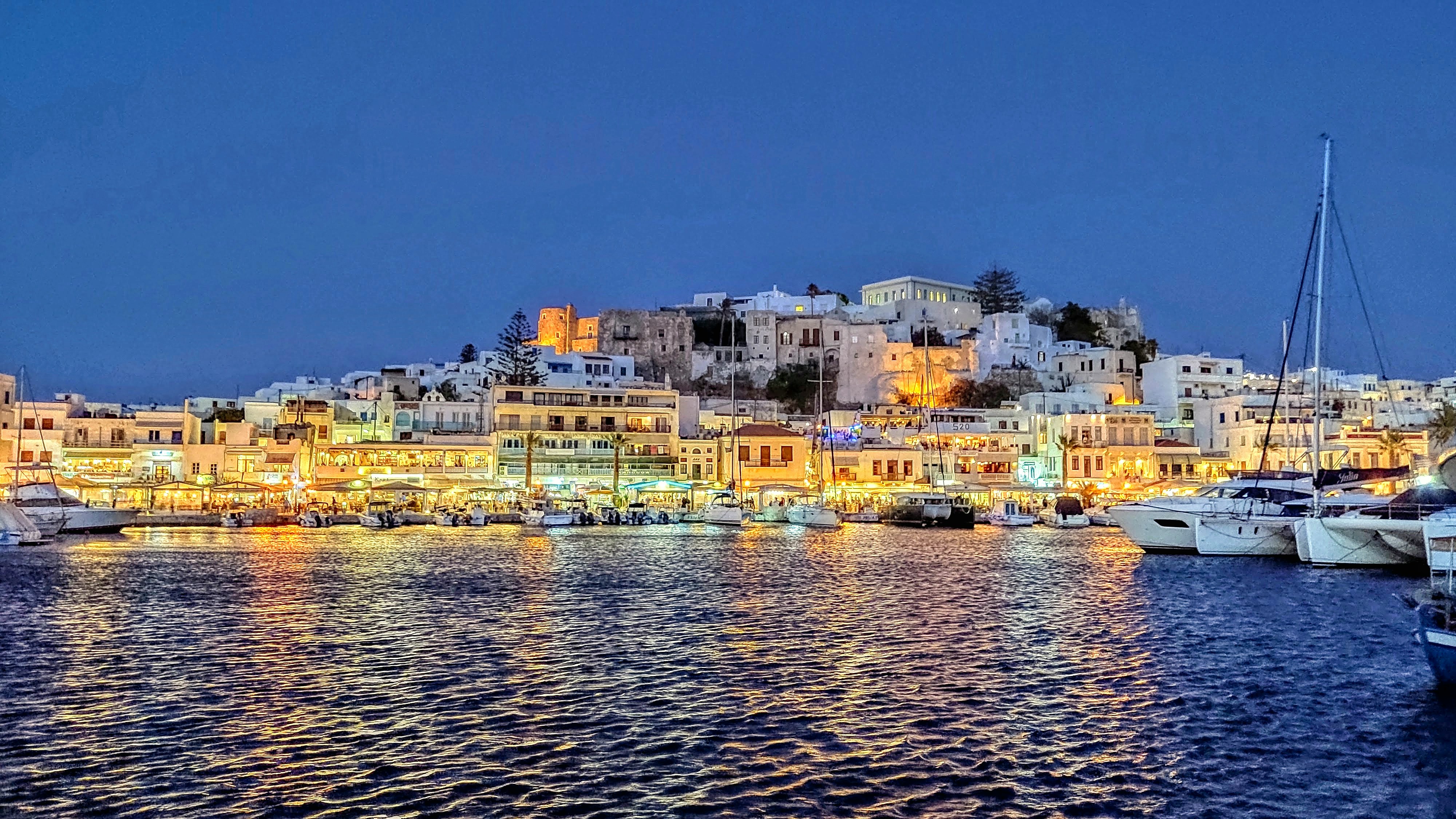 luxury yacht charter surrounded by white buildings and blue domes in Santorini